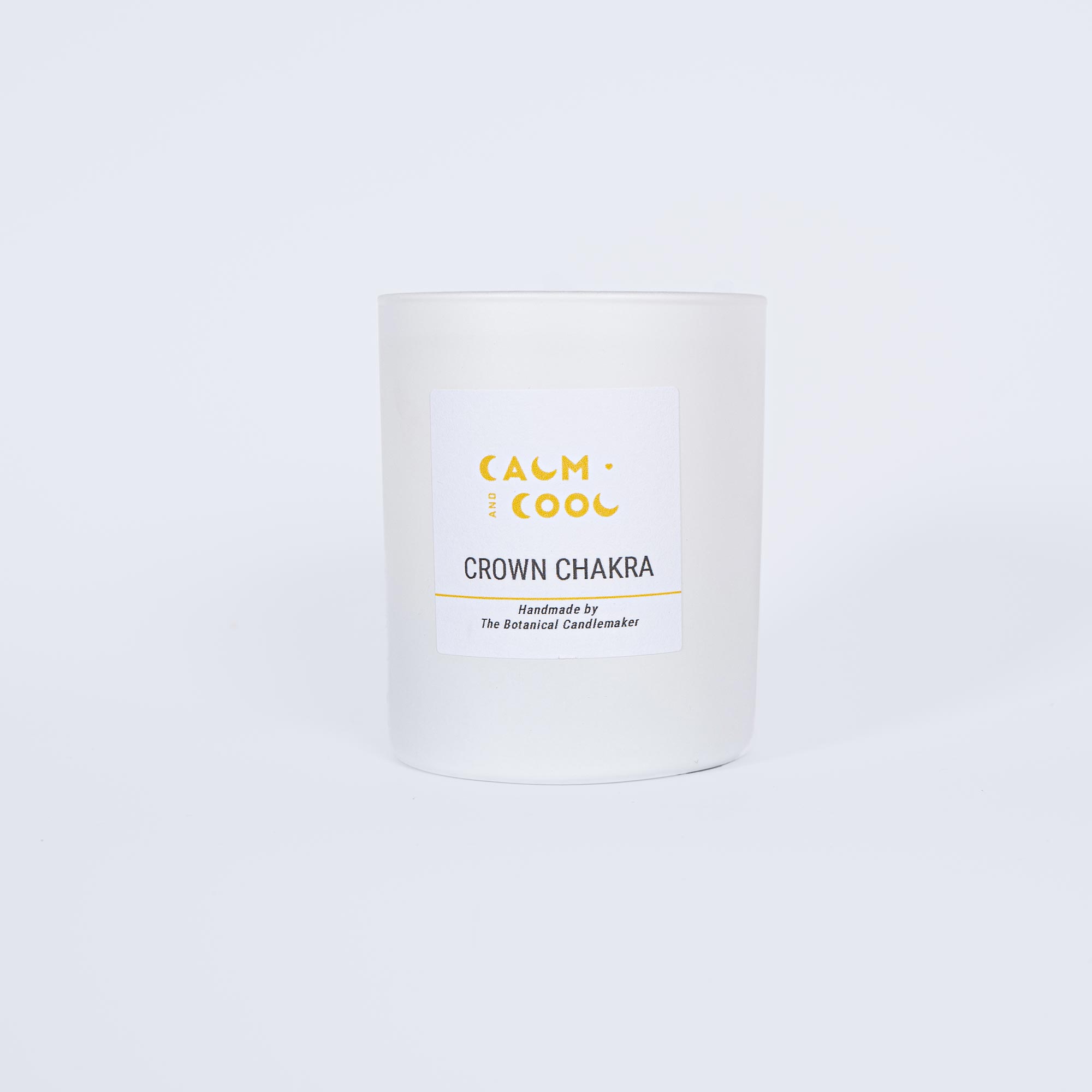 White candle labeled Calm and Cool Crown Chakra on white background