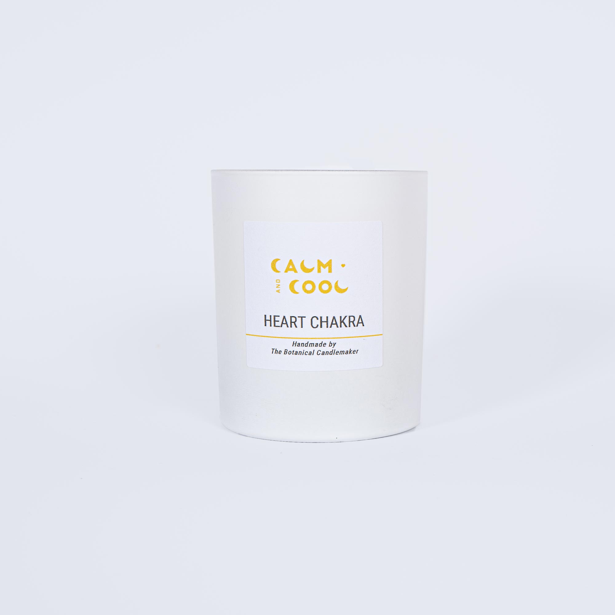 White candle labeled Heart Chakra for wellness and relaxation