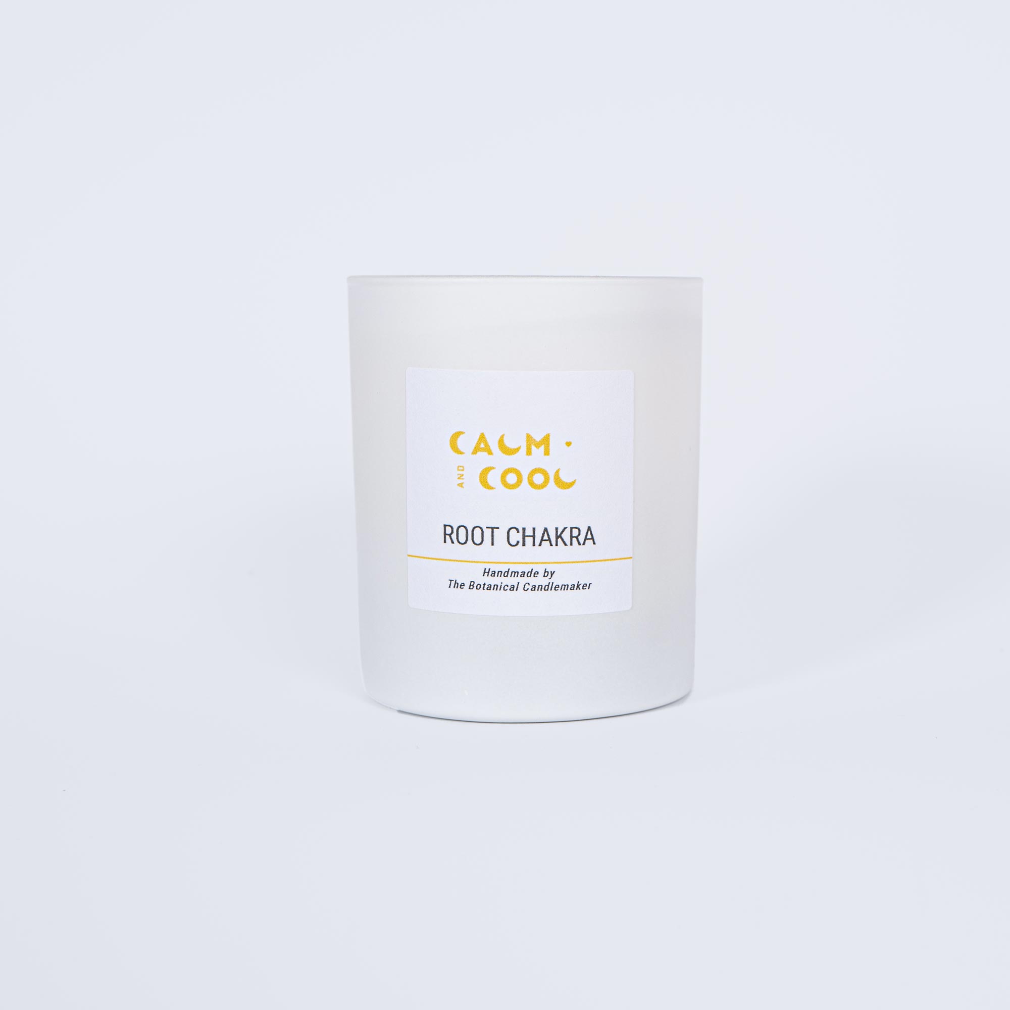 White scented candle labeled Root Chakra for relaxation.
