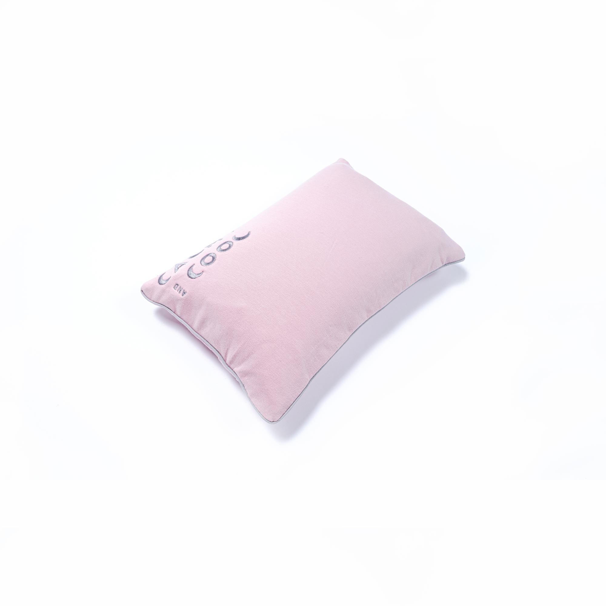 Soft pink cushion on white background for home decor styling