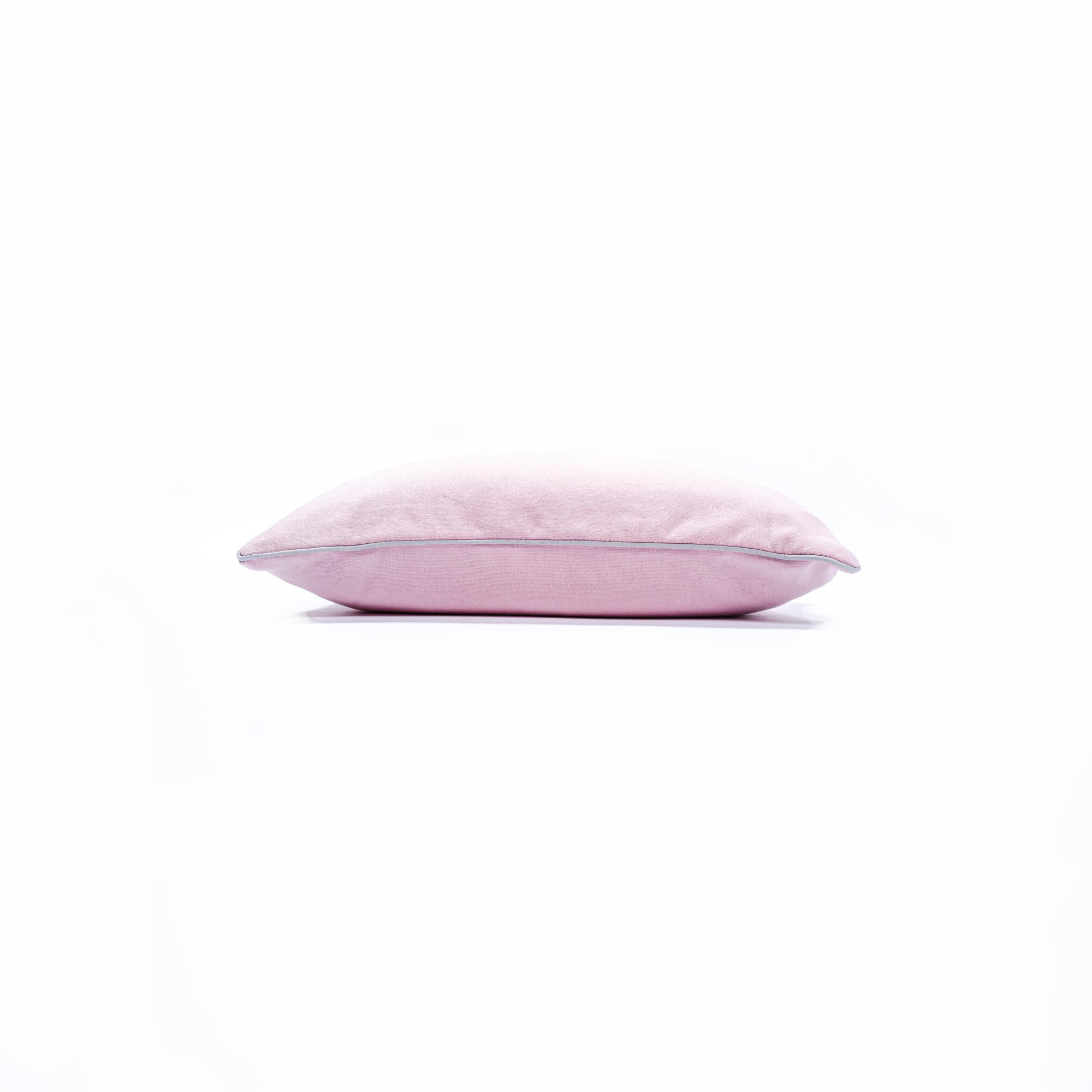Soft pink pillow on a white background for home comfort