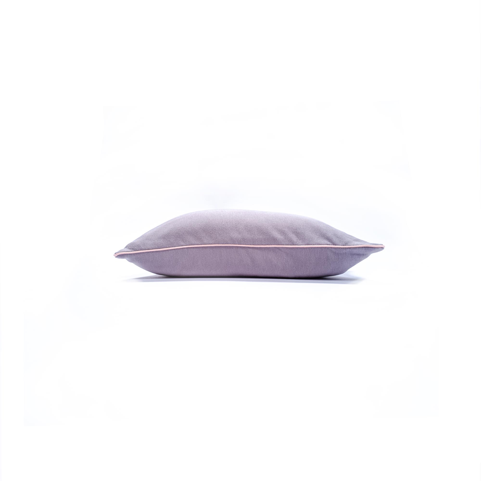 Simple lavender pillow against a plain white background