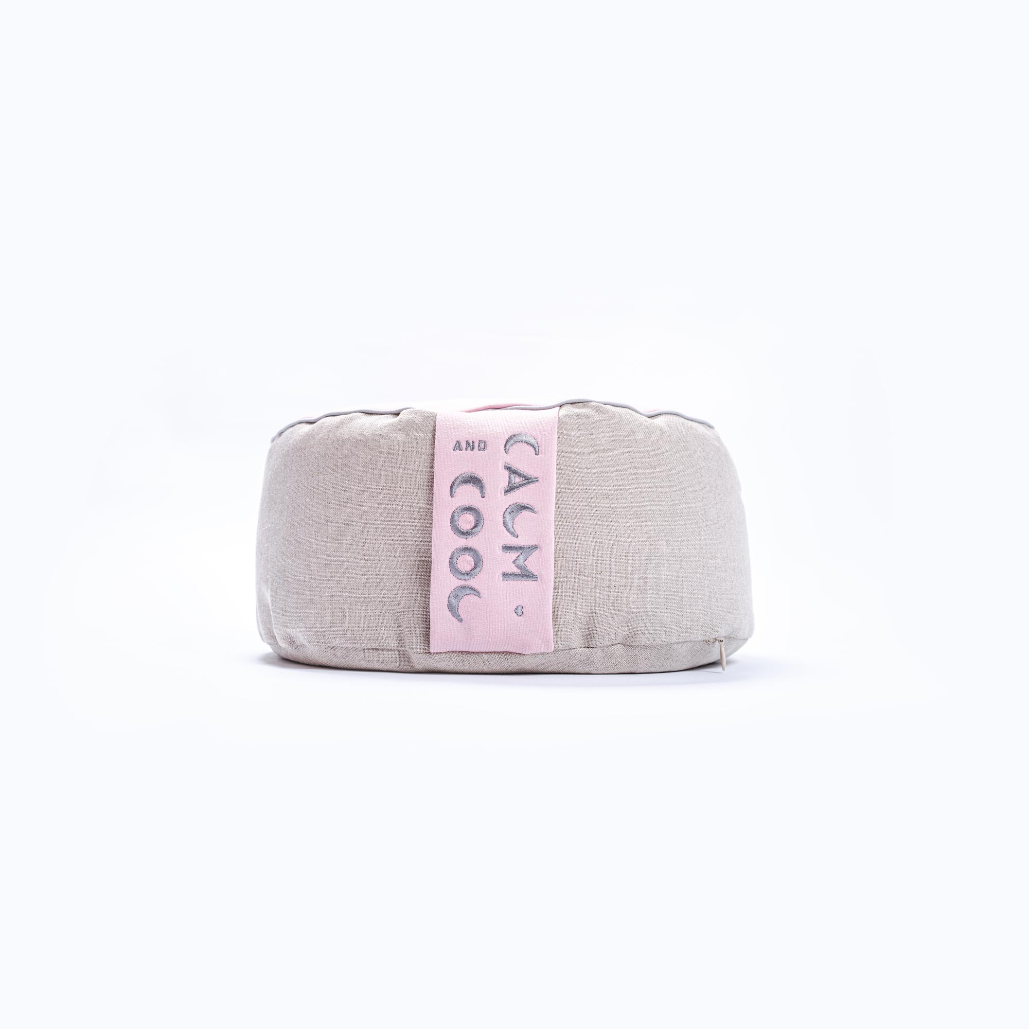 Gray meditation cushion with pink Calm and Cool label visible.