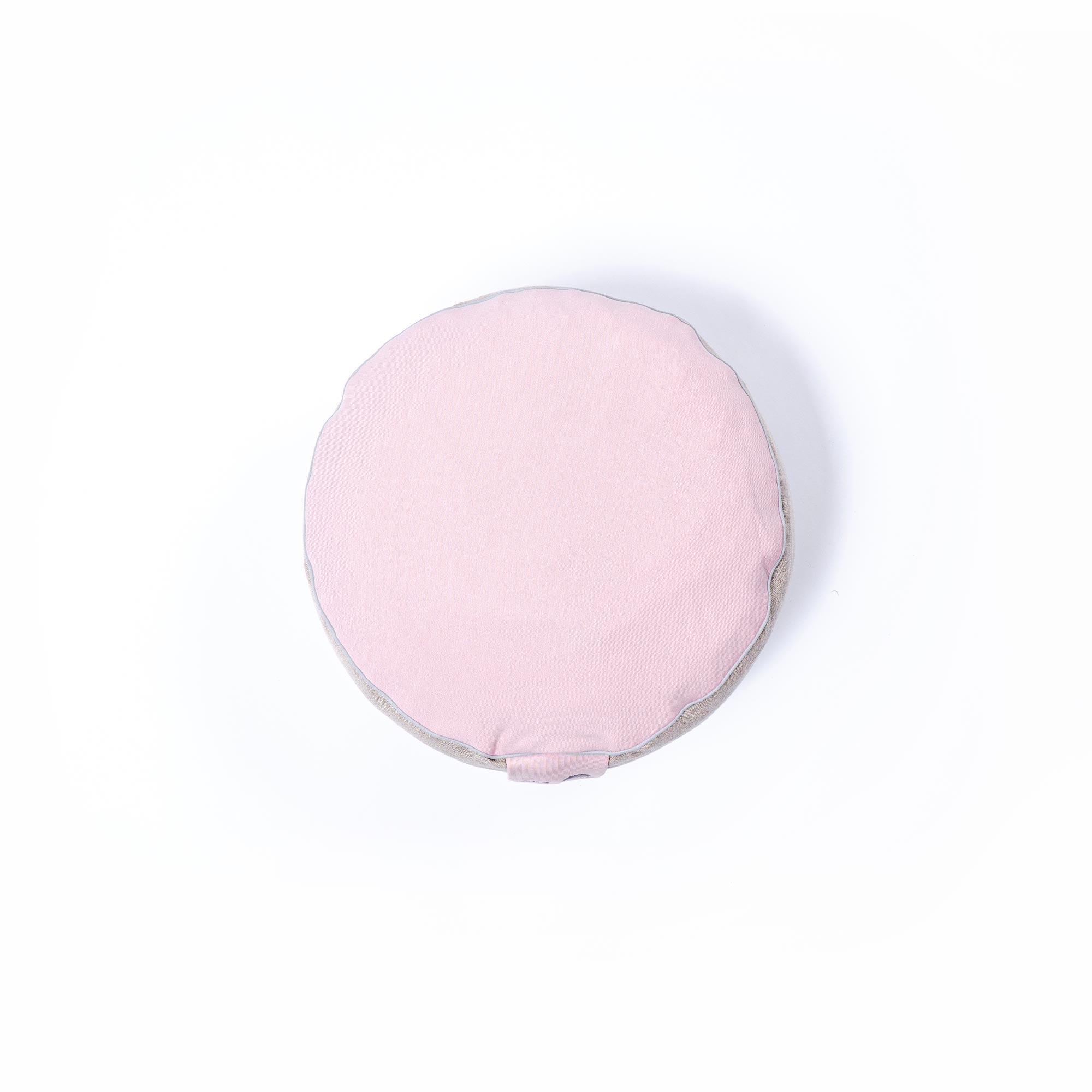 Soft round pink cushion on a white background for home decor