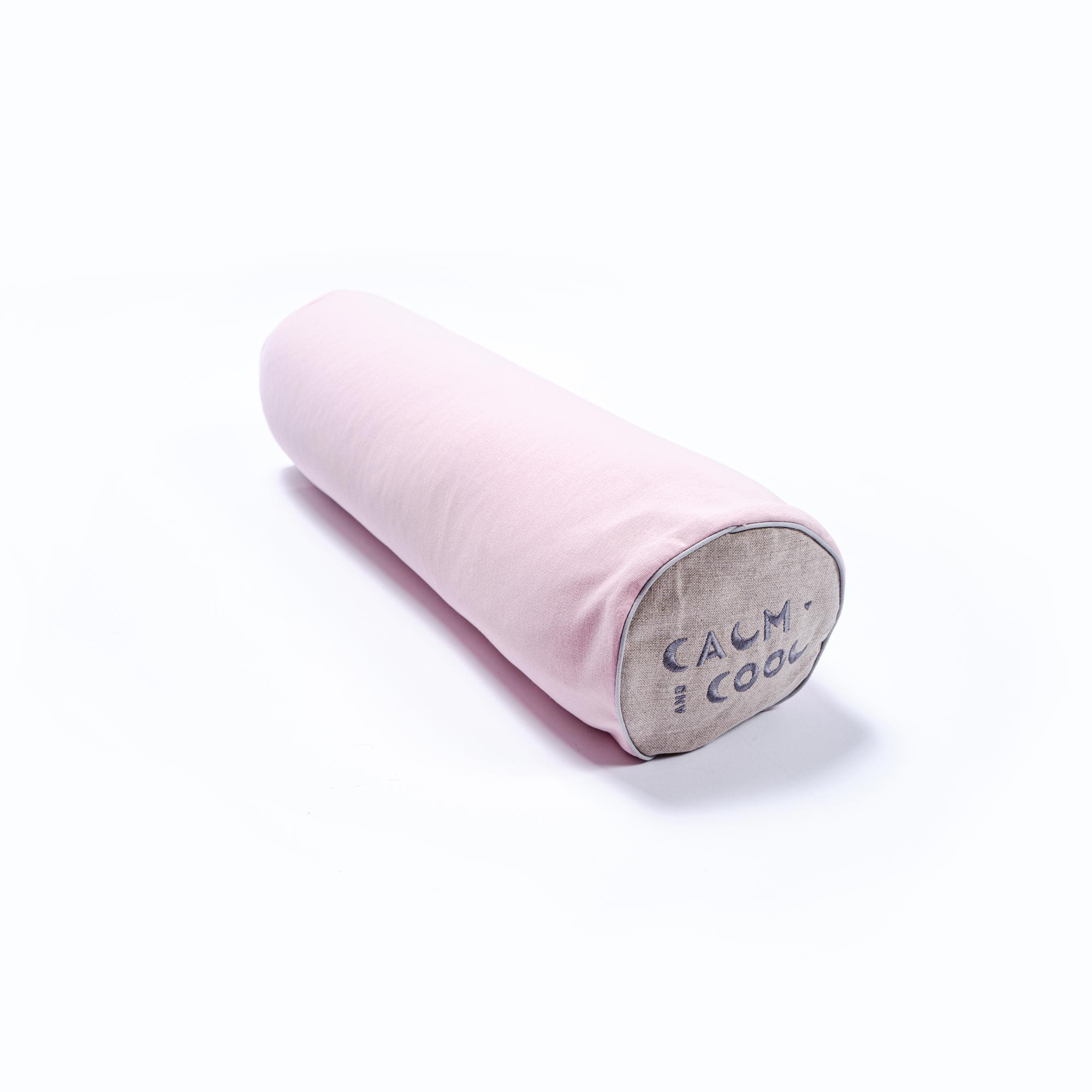 Soft pink bolster pillow with gray ends on a white background