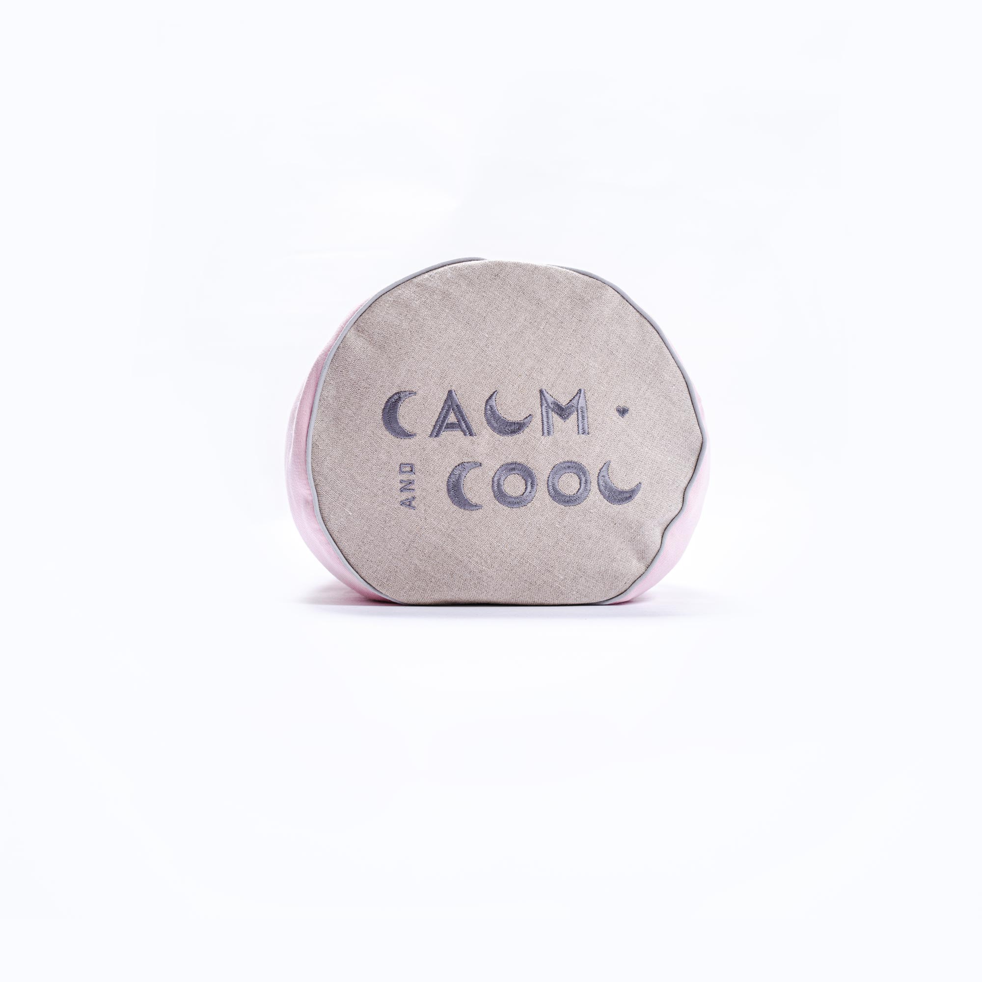 Cushion with Calm and Cool text on soft fabric background