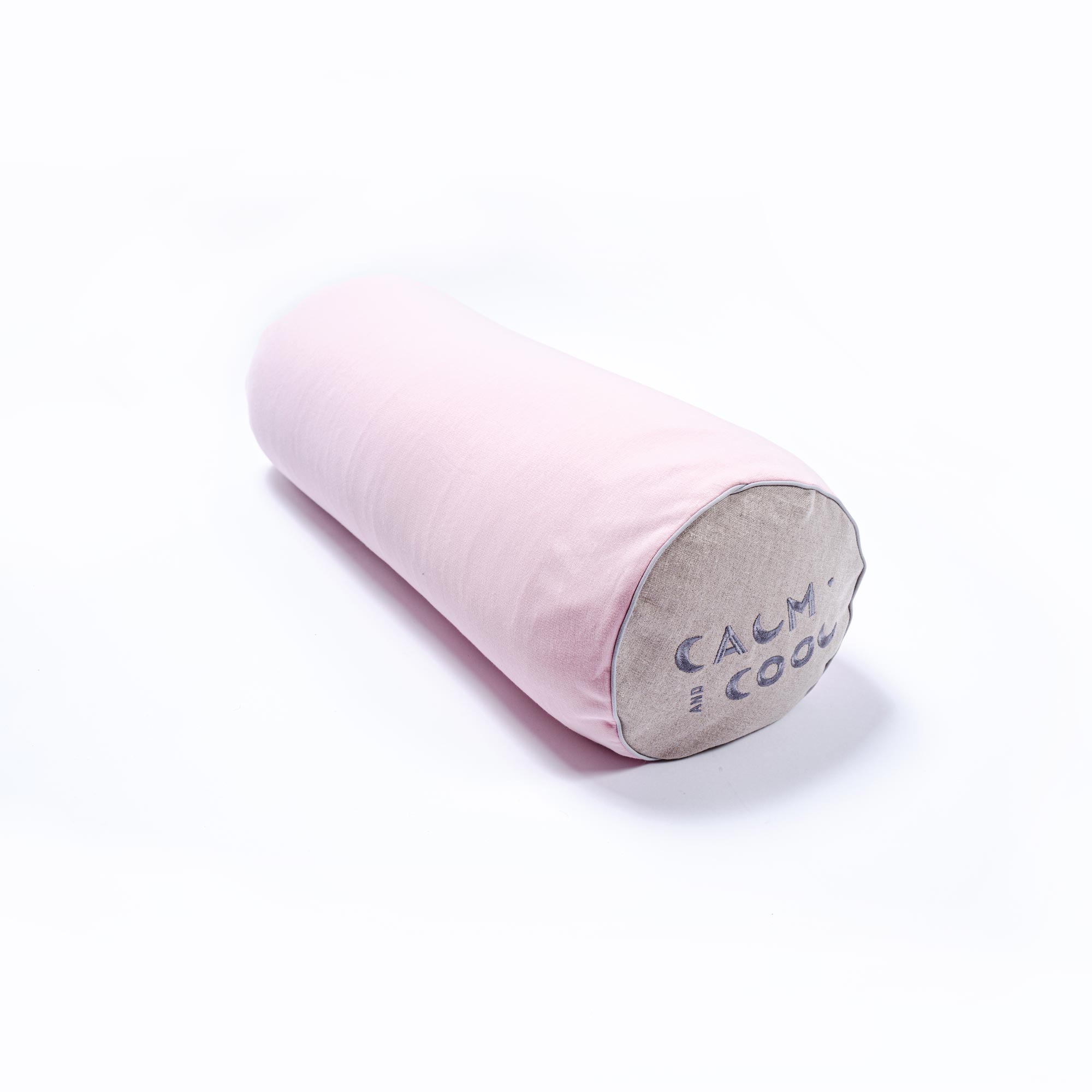 Pink cylindrical pillow with calm and cool text at the end