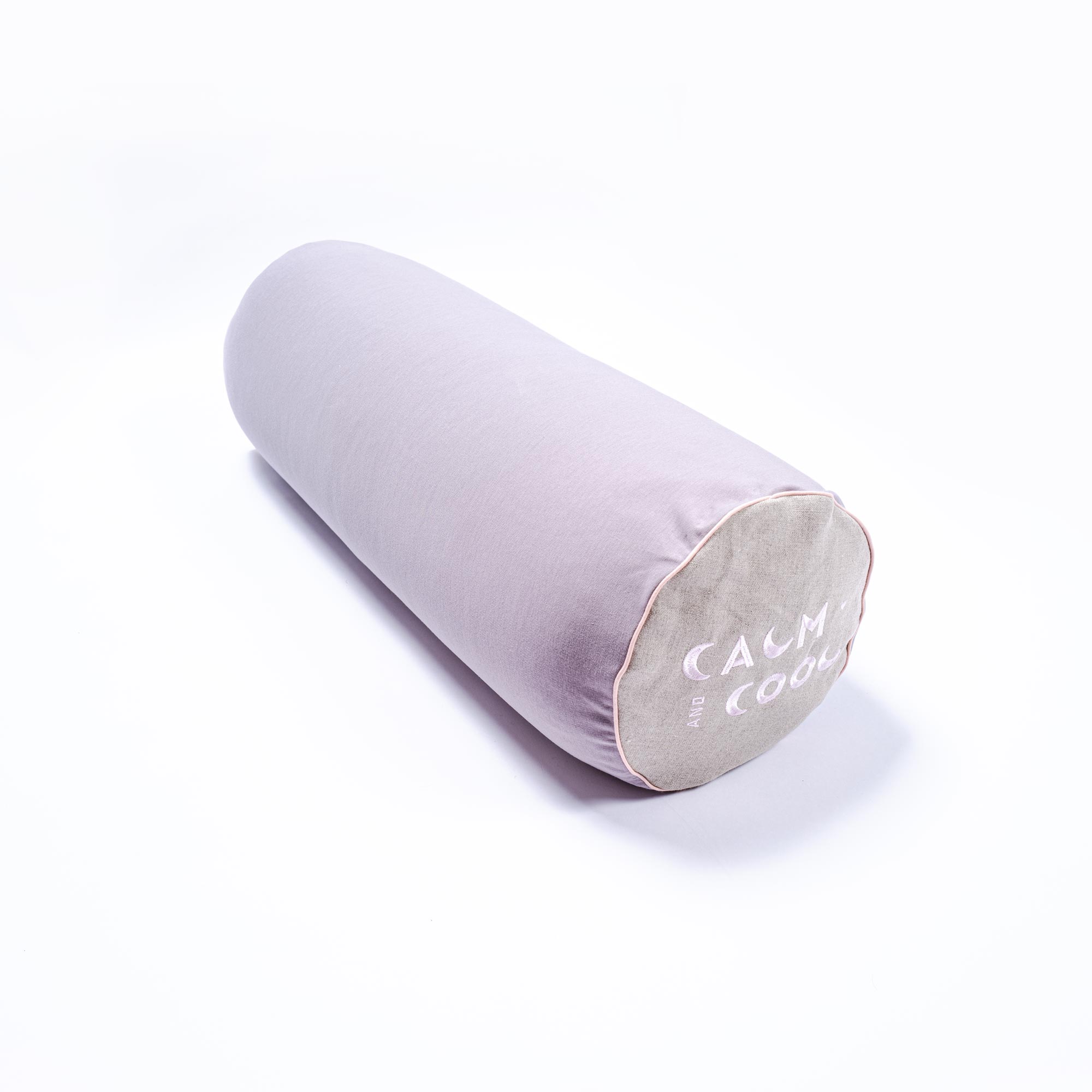 Cylindrical purple bolster pillow on white background elegant design