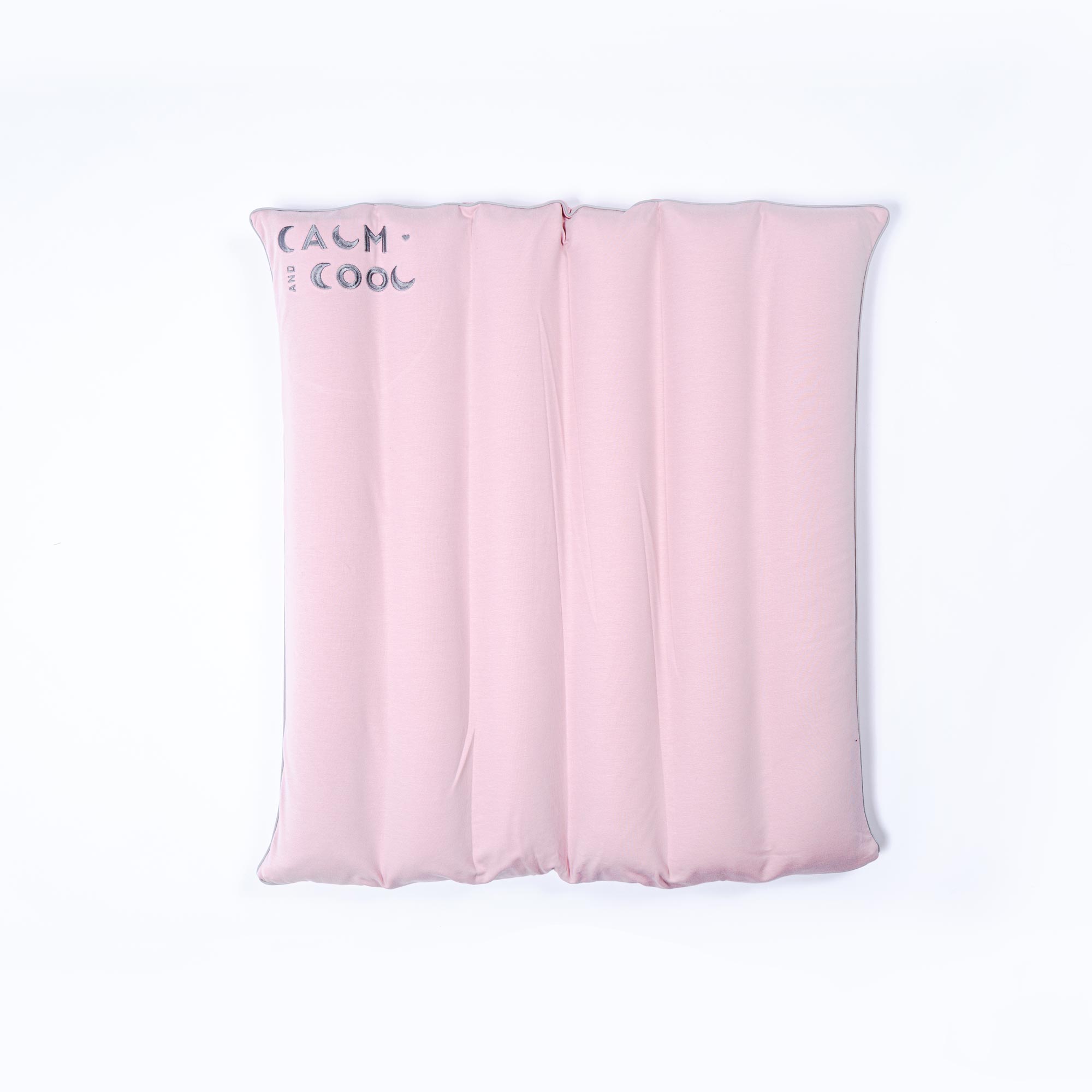 Pink inflatable cushion against white background with text Calm.