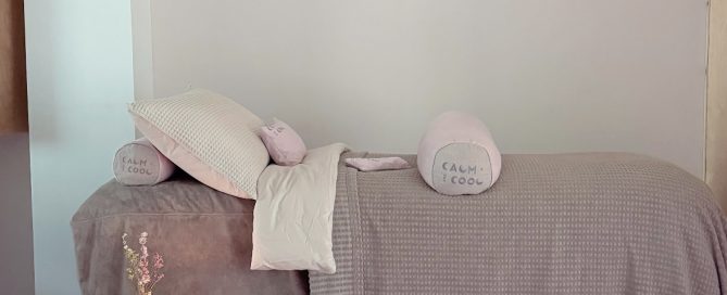 Cozy spa treatment room with soft bedding and calming decor