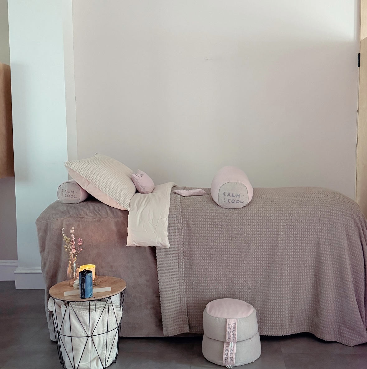 Cozy spa treatment room with soft bedding and calming decor