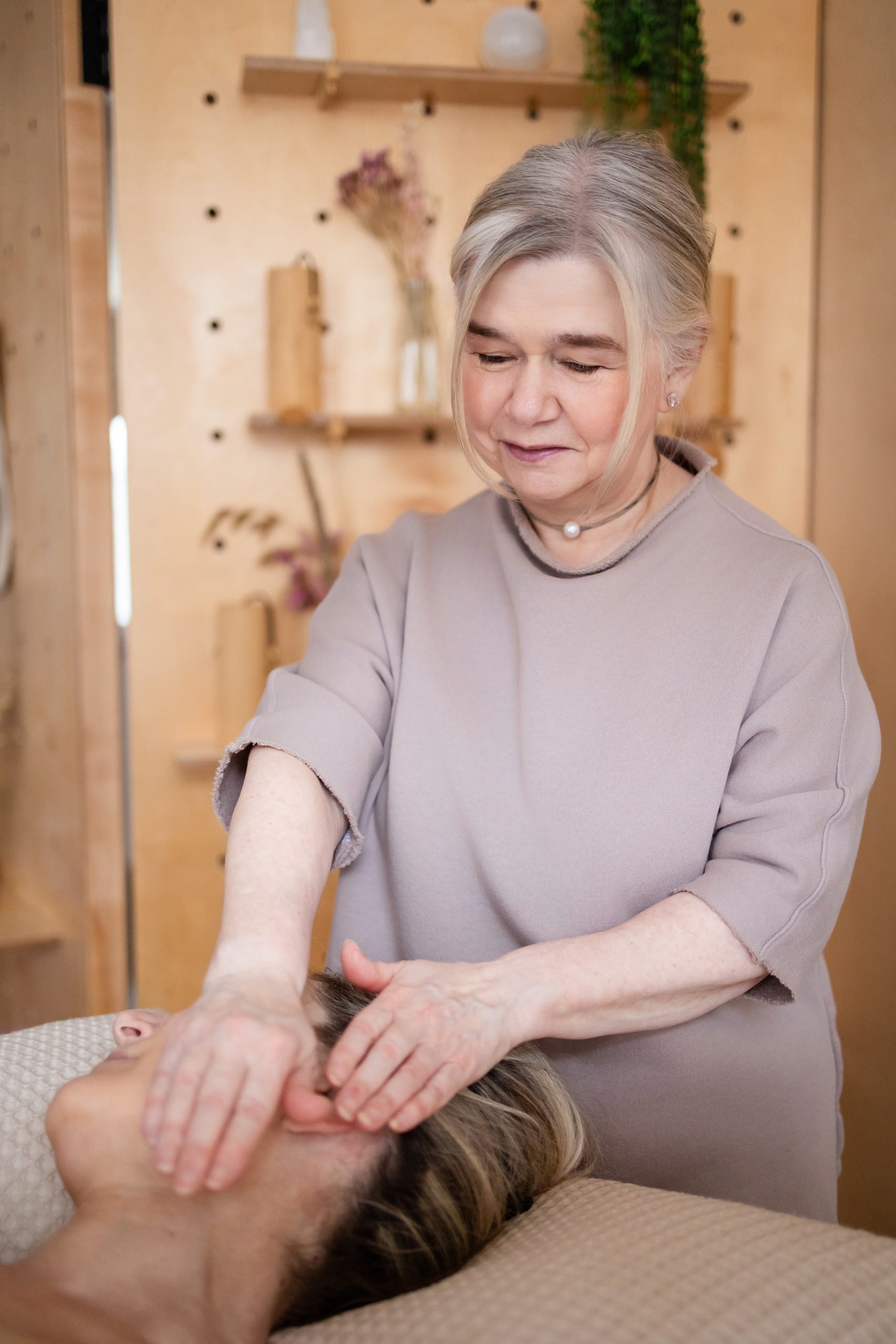 Elderly woman giving a relaxing massage in a cozy spa room Elderly woman giving a relaxing massage in a cozy spa room