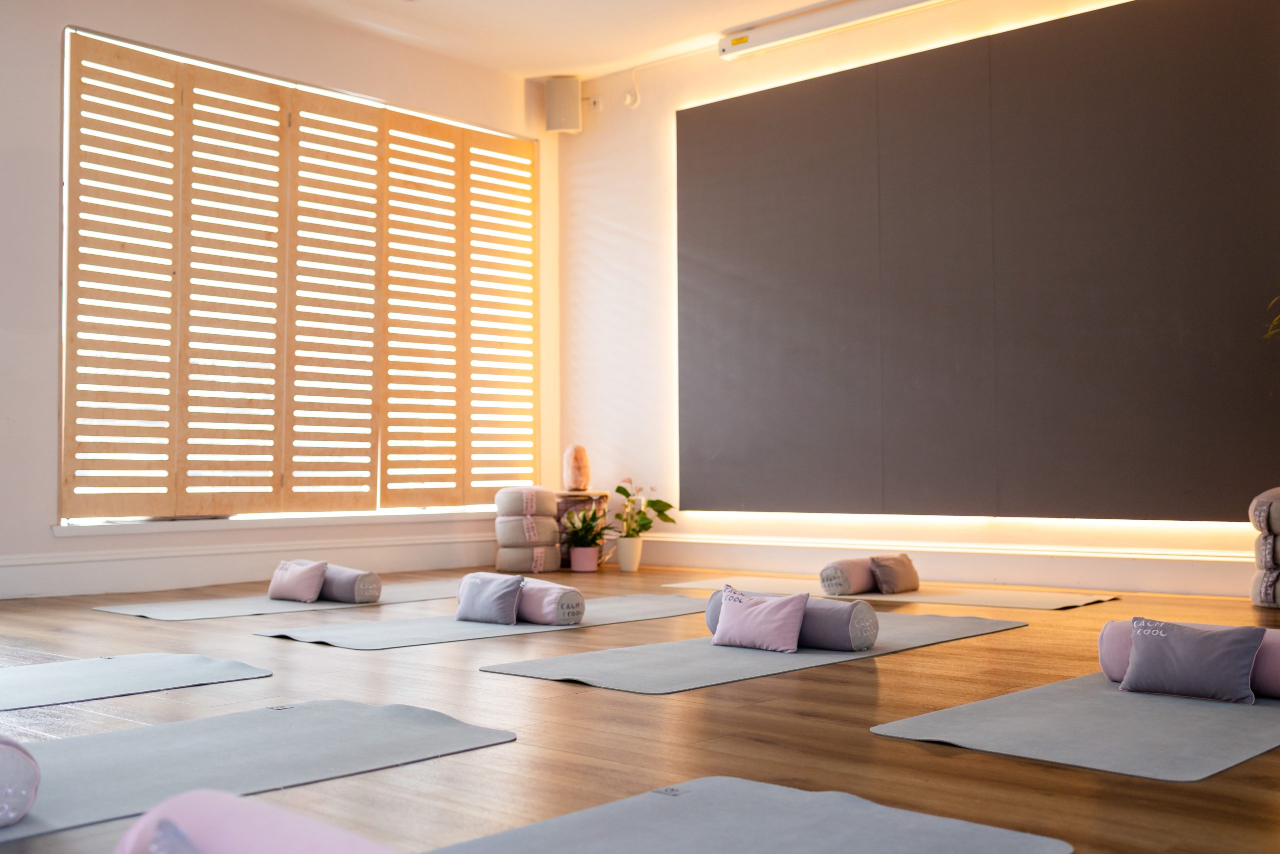 Peaceful yoga studio with mats and cushions in soft lighting