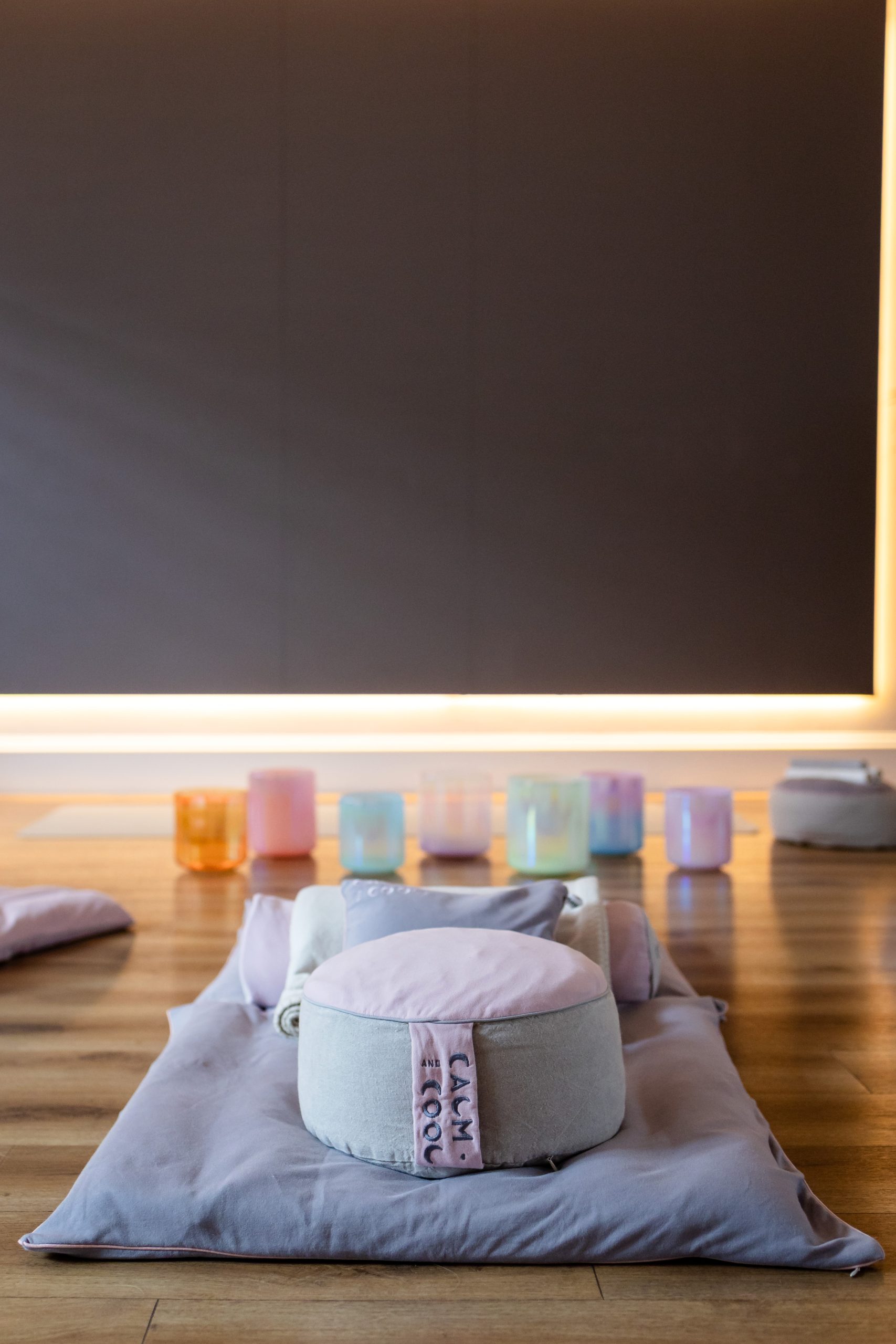 Meditation cushions and colorful bowls in a serene yoga studio Meditation cushions and colorful bowls in a serene yoga studio
