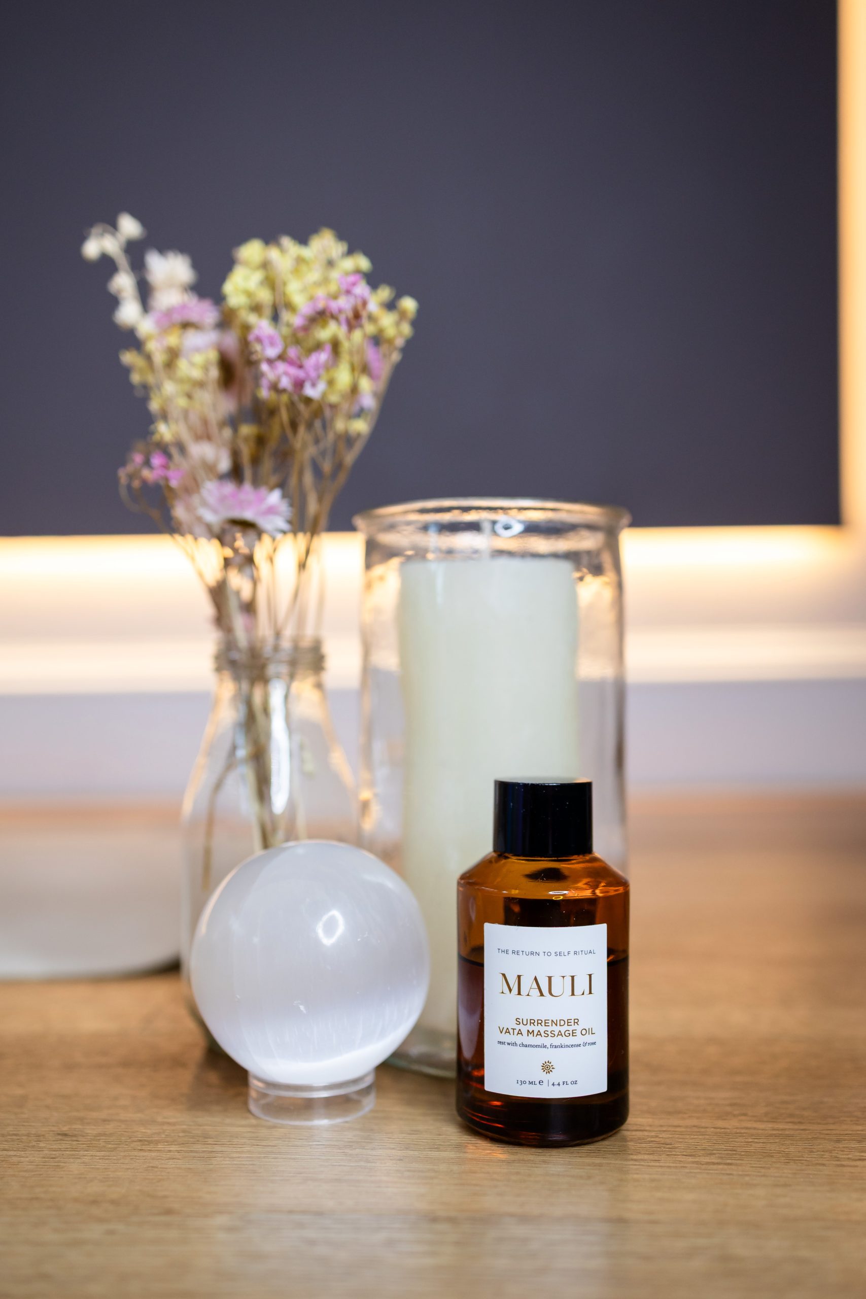 Aromatherapy oil with candle and dried flowers on a wooden table Aromatherapy oil with candle and dried flowers on a wooden table