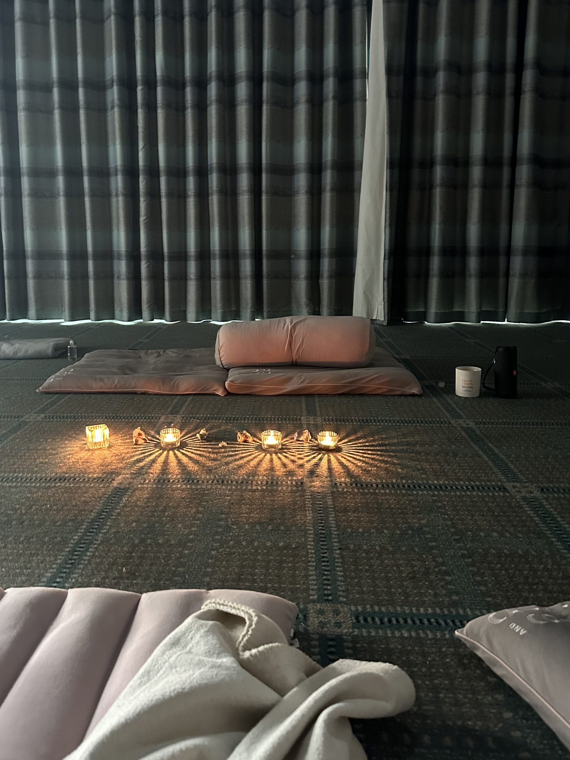 Peaceful meditation room with cushions and glowing candles