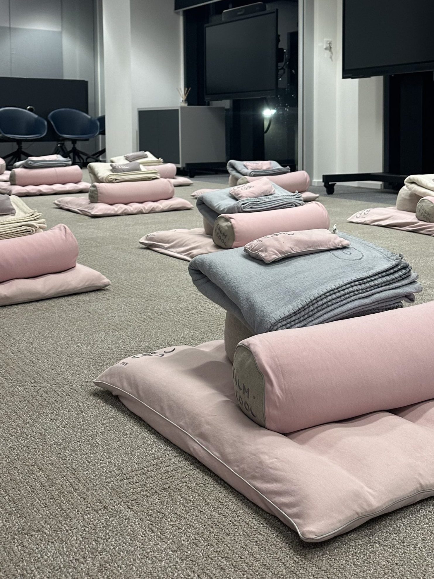 Meditation room with cushions and soft blankets arranged neatly