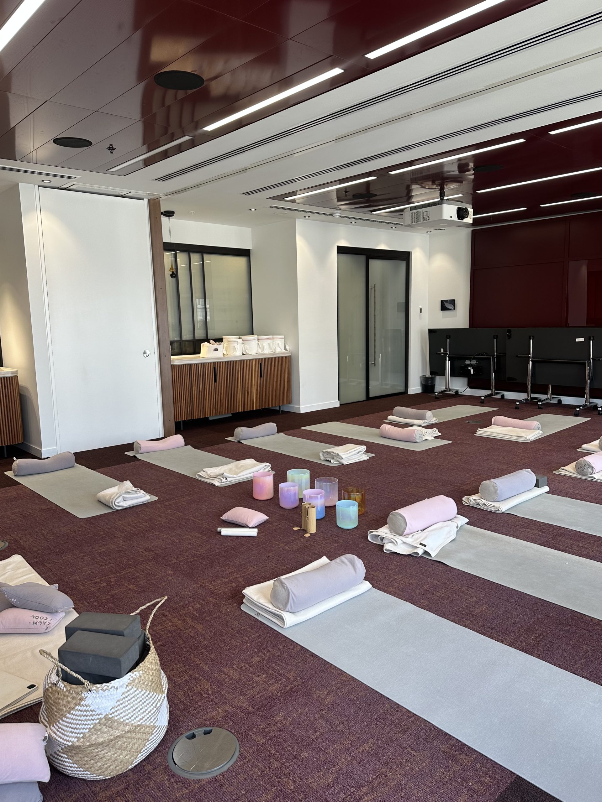 Yoga studio with mats and meditation cushions set up inside