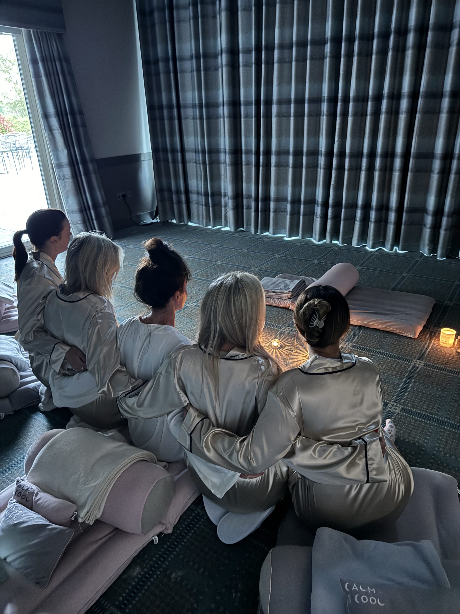Women in silk robes enjoying a peaceful group meditation session
