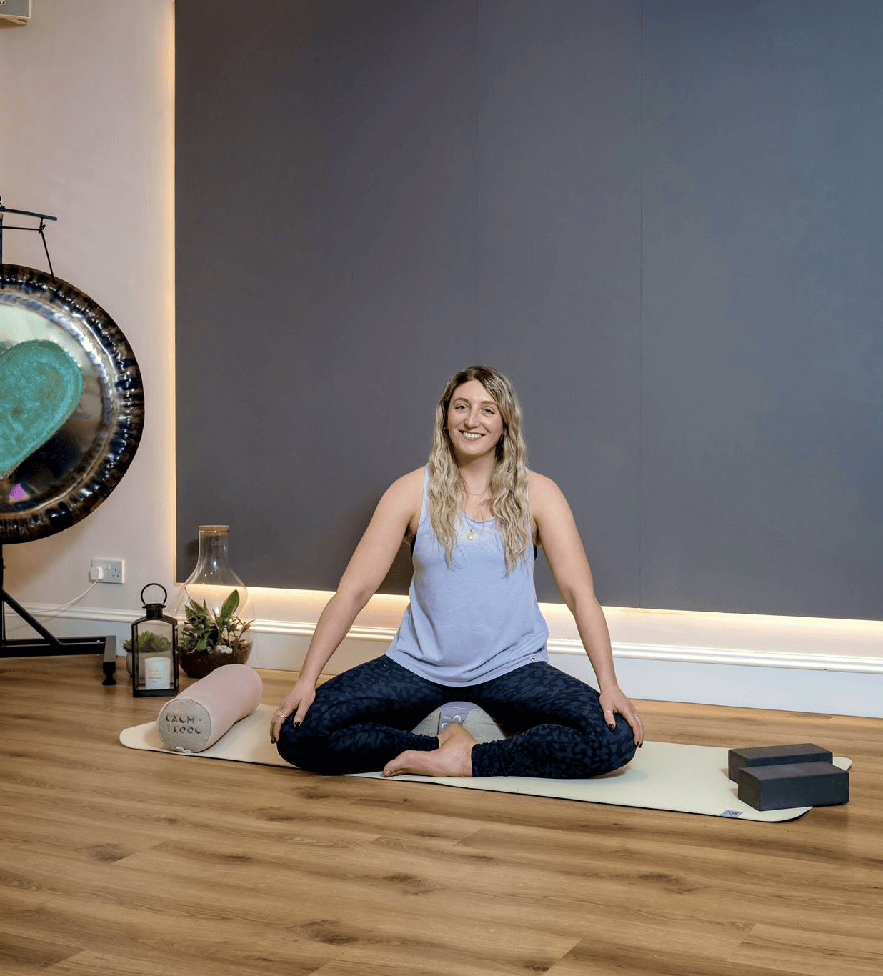 Woman practicing yoga on mat in peaceful studio setting