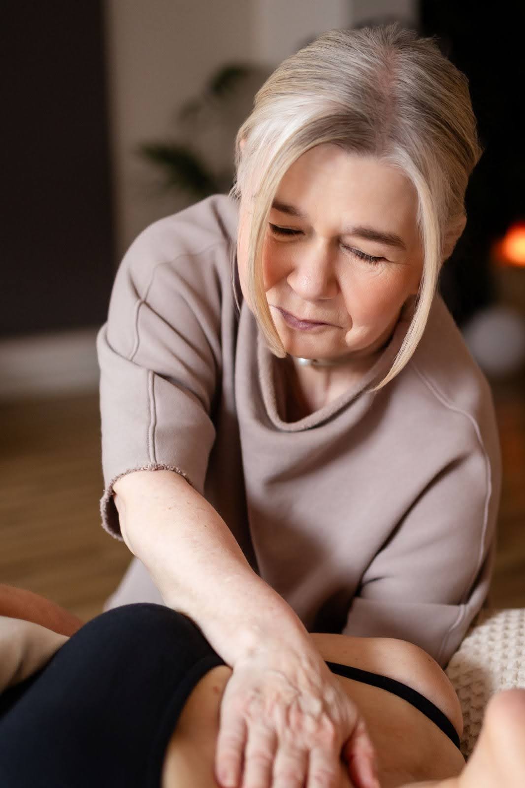 Experienced female therapist performing relaxing massage therapy