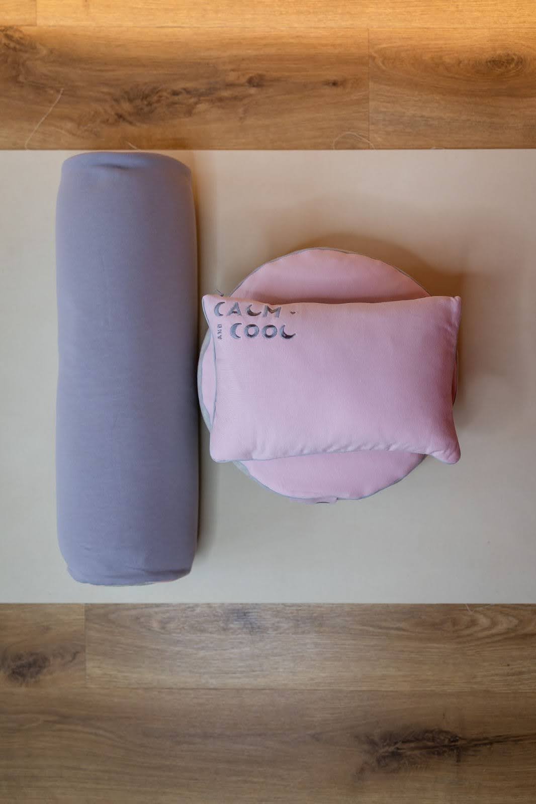 Pink and gray pillows on wooden floor minimal design