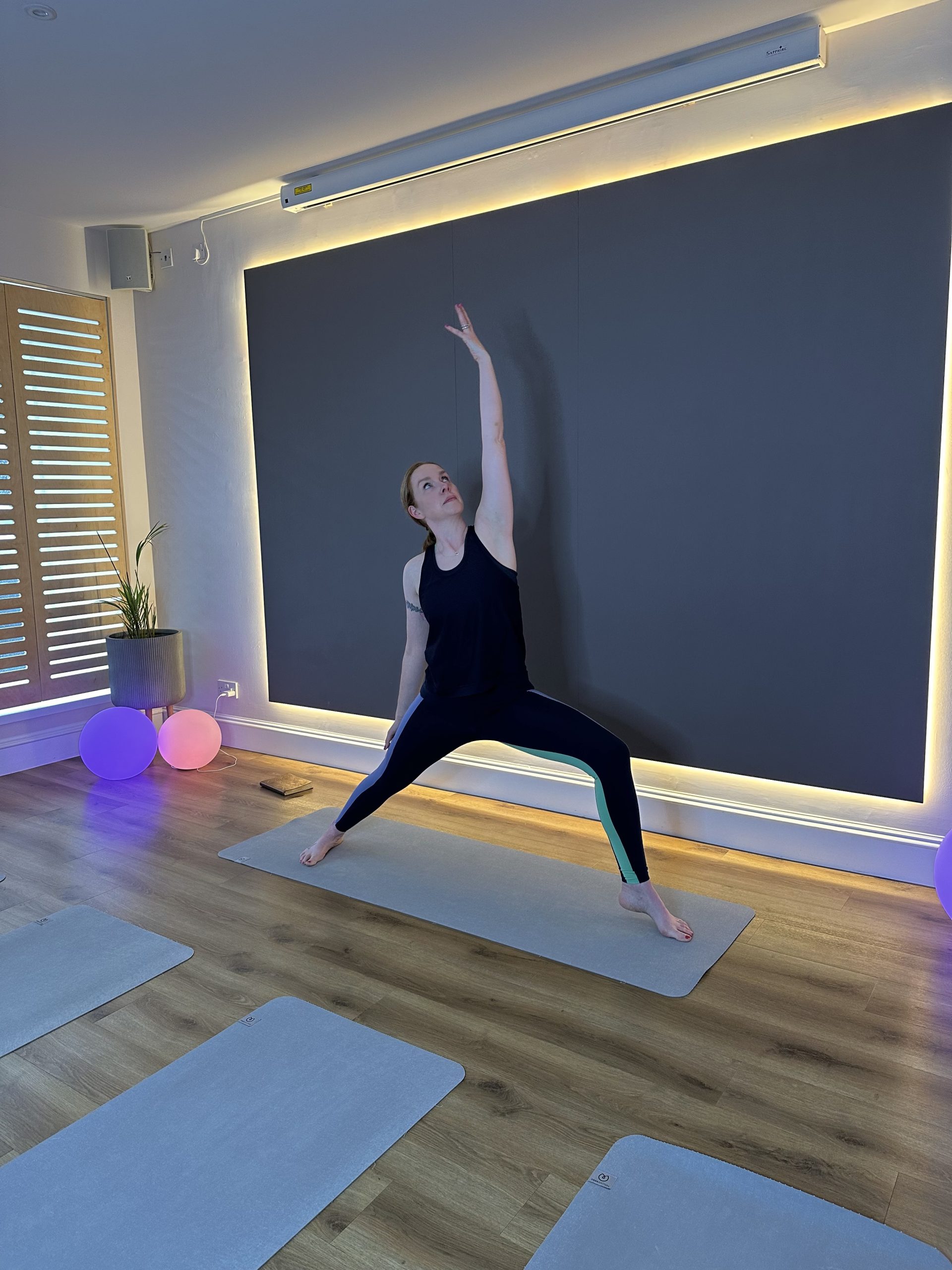 Person practicing yoga in peaceful modern studio setting